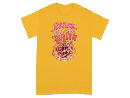 Yellow t-shirt with "Peace Blooms Through Faith Held in His Mercy" text and floral cross design.