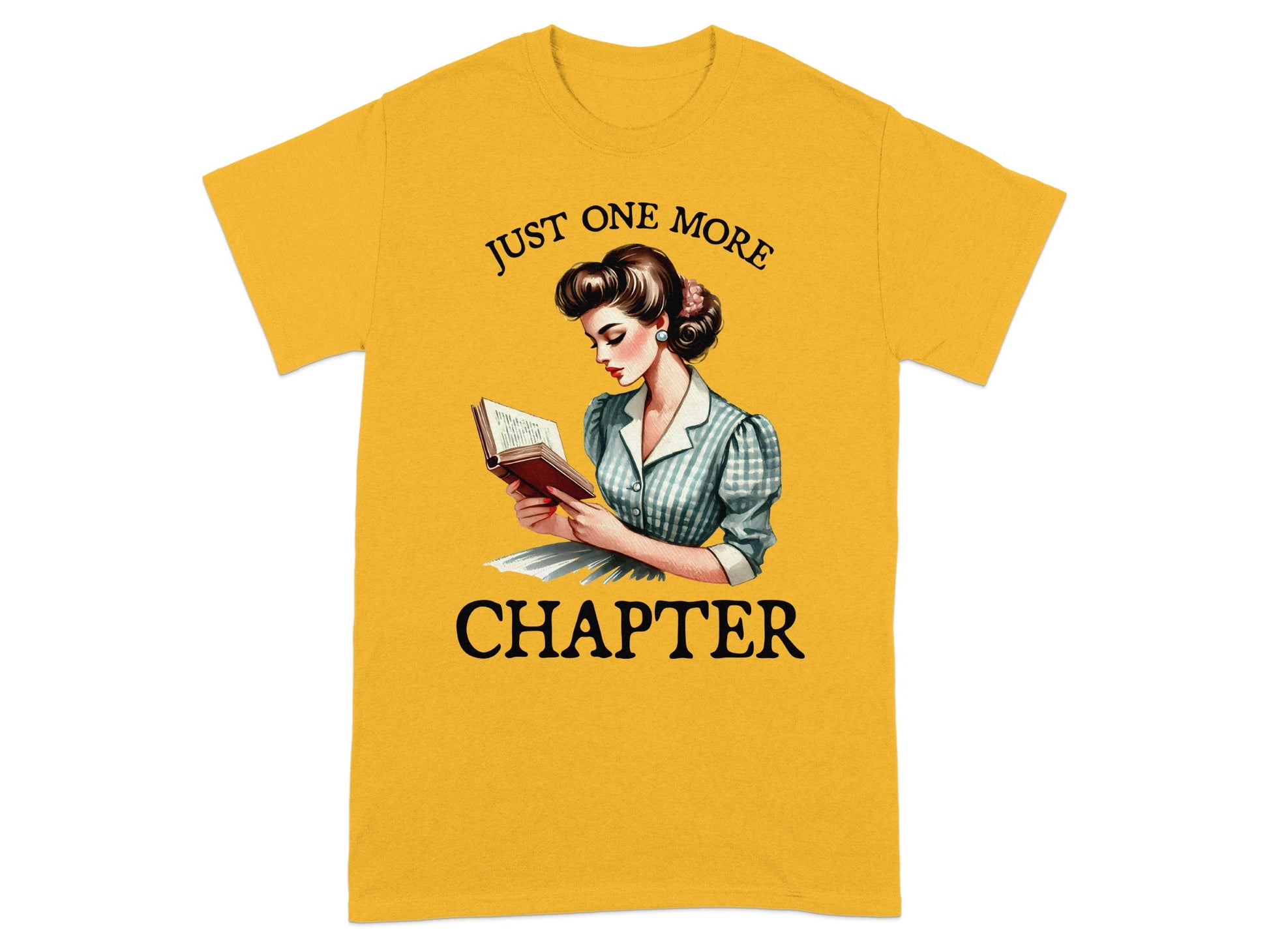Yellow t-shirt with a graphic of a woman reading, text "JUST ONE MORE CHAPTER".