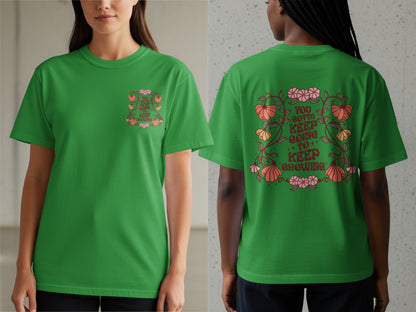Green t-shirt with "You Gotta Keep Going To Keep Growing" text and floral design.