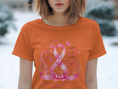 Orange t-shirt with a breast cancer awareness graphic featuring a pink ribbon and inspirational text.
