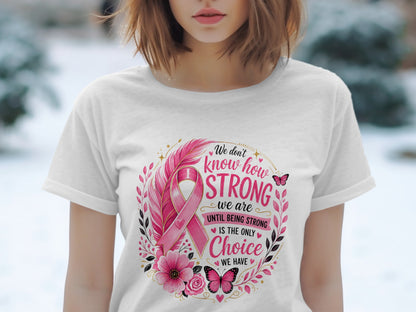 White t-shirt with pink breast cancer ribbon design and empowering text about strength.