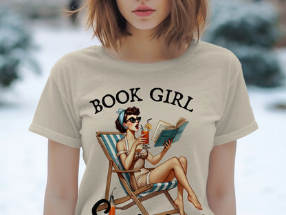 T-shirt with "BOOK GIRL" text and illustration of woman reading in deck chair.