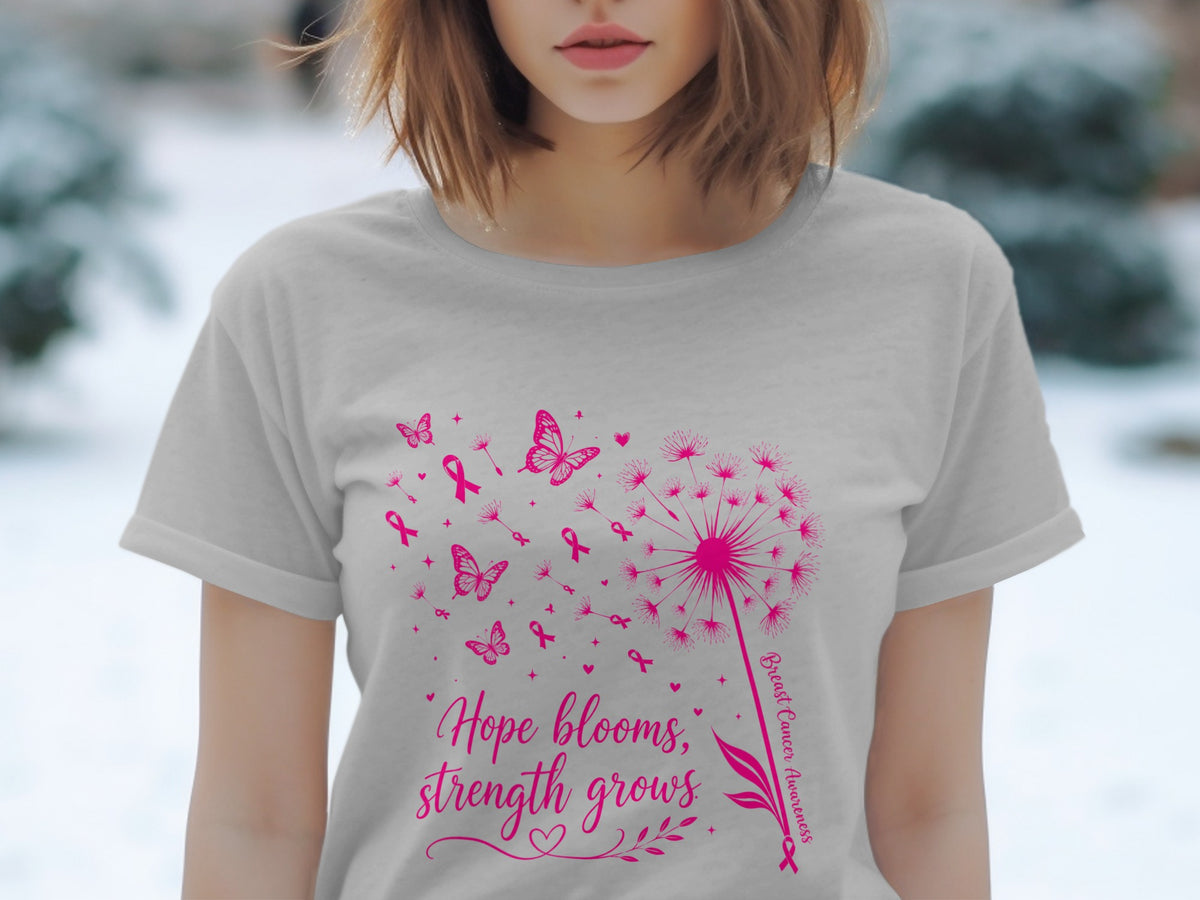 Gray t-shirt with pink dandelion, butterflies, ribbons, and text "Hope blooms, strength grows."