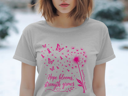 Gray t-shirt with pink dandelion, butterflies, ribbons, and text "Hope blooms, strength grows."