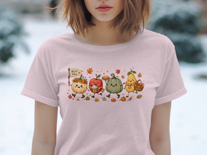 Cute autumn characters, including pumpkins, apple, and pear, on a pink t-shirt.