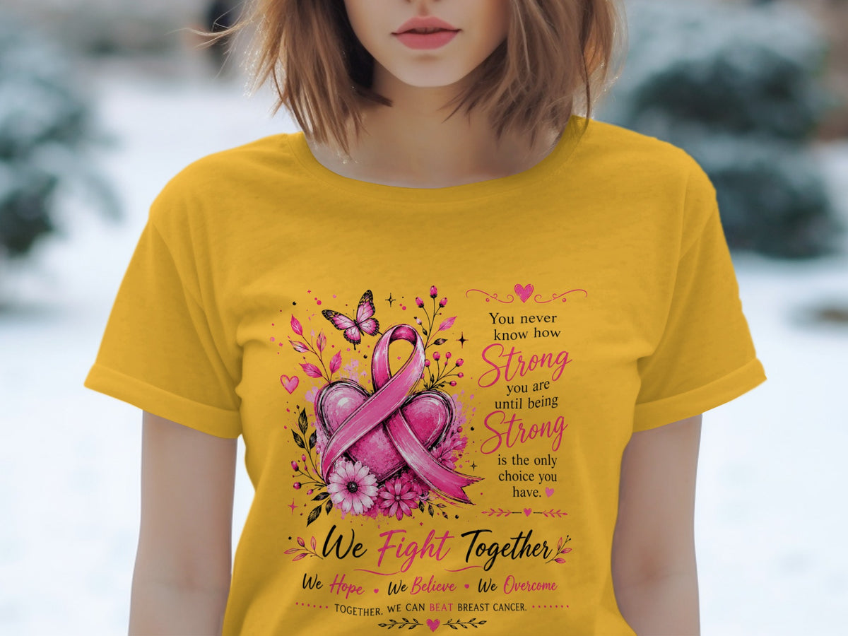 Yellow t-shirt with pink breast cancer ribbon, hearts, flowers, and motivational text.