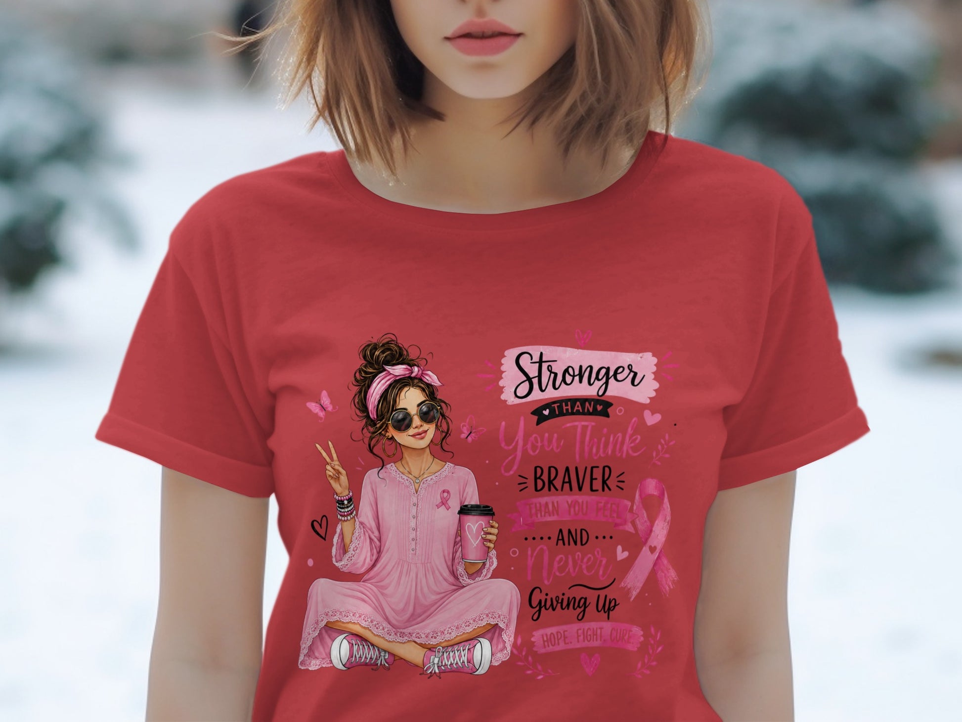 Girl with coffee and pink ribbon saying "Stronger than you think braver than you feel and never giving up".