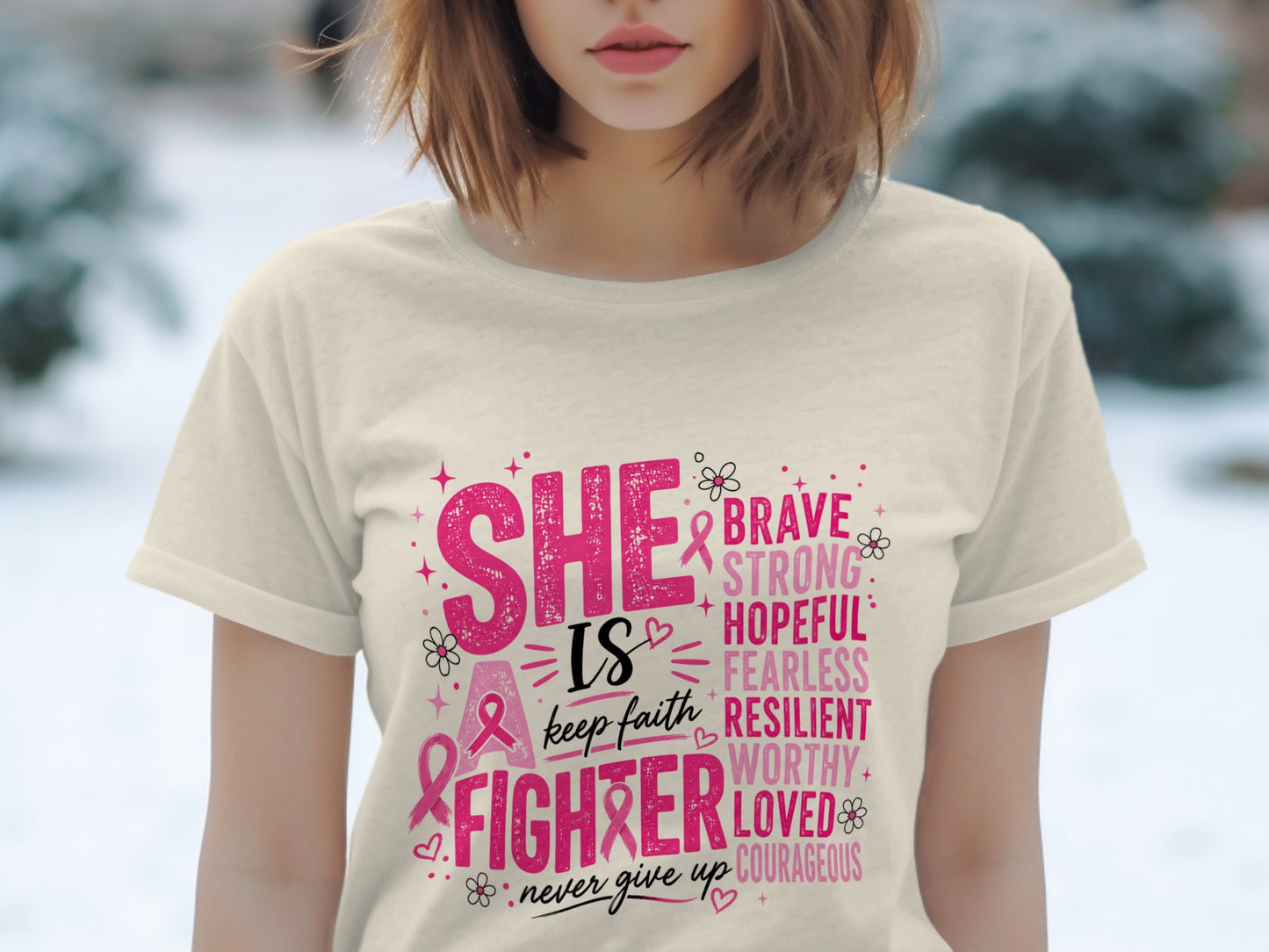 Cream t-shirt with pink text "SHE IS A FIGHTER" and words brave, strong, hopeful, fearless, resilient, worthy, loved, courageous.