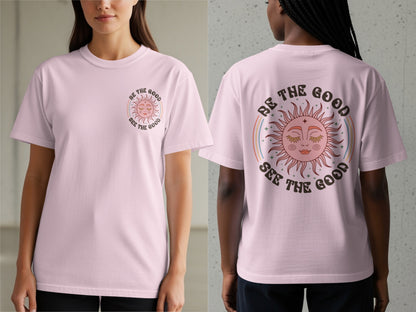 Pink t-shirt with a sun graphic and text "Be the Good See the Good".