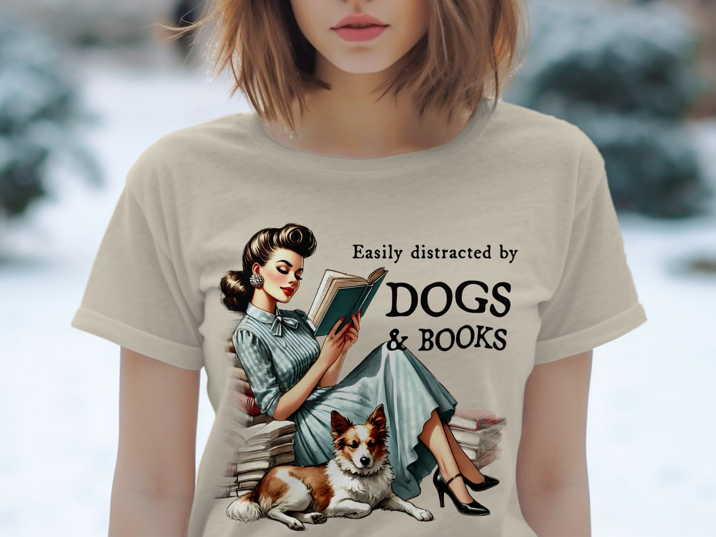 T-shirt with a retro illustration of a woman reading next to a dog, "Easily distracted by DOGS & BOOKS".