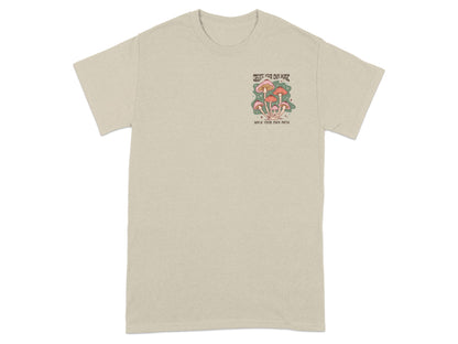 Beige t-shirt with a small graphic of mushrooms and text.