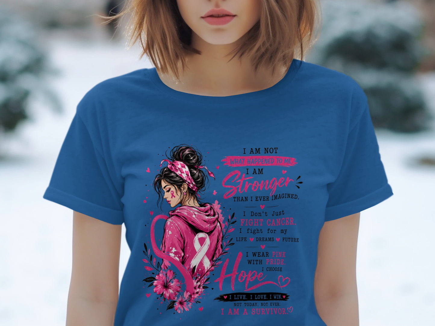 Woman wearing blue shirt with "I am stronger than I ever imagined" text and pink ribbon.