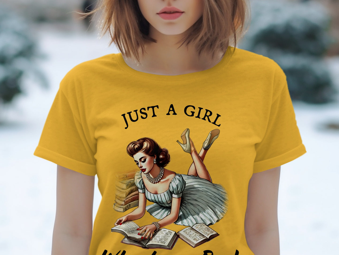 Yellow t-shirt with "Just a girl" text and illustration of a woman reading books.