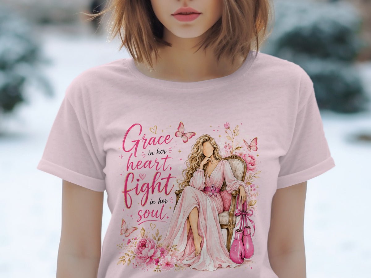 Pink t-shirt with a watercolor design of a woman, boxing gloves, and "Grace in her heart, fight in her soul."