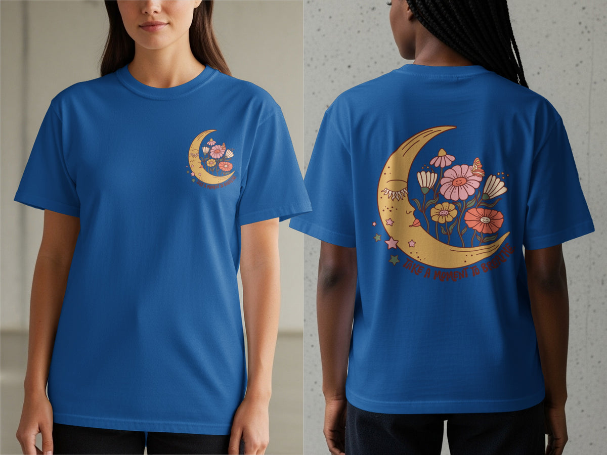 Blue t-shirt with a crescent moon, flowers, and the text "Take a moment to breathe".