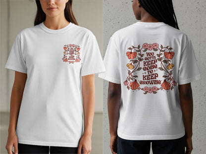 White t-shirt with floral design and text "You gotta keep going to keep growing".