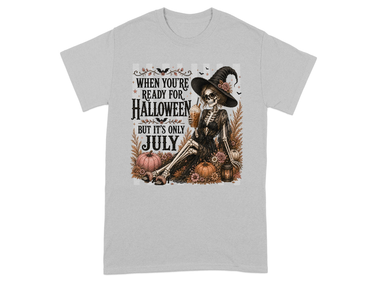 Skeleton in witch hat holding drink, with text "When You're Ready for Halloween But It's Only July".