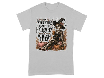 Skeleton in witch hat holding drink, with text "When You're Ready for Halloween But It's Only July".