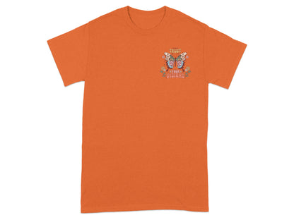 Orange t-shirt with a butterfly graphic and text "TRUST YOUR VISIONS."