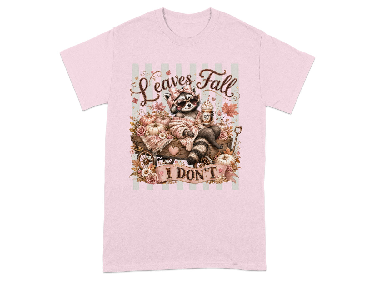 Raccoon in a wagon with pumpkins and flowers, text "Leaves Fall I DON'T".