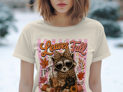 T-shirt graphic with raccoon, black cat, coffee, and "Leaves Fall I Don't" text.