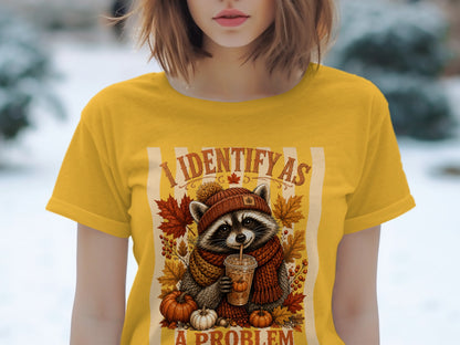 Yellow t-shirt with graphic of raccoon drinking coffee, "I IDENTIFY AS A PROBLEM".