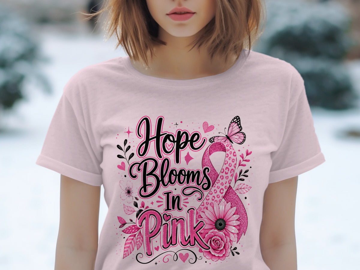 Pink t-shirt with "Hope Blooms In Pink" text and breast cancer awareness ribbon graphic.