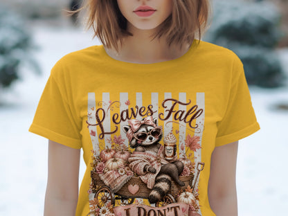 Raccoon in sunglasses on wagon with pumpkins and leaves, text "Leaves Fall".