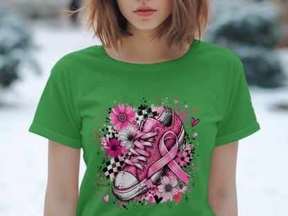 Pink glitter sneaker with breast cancer ribbon and floral design on green shirt.