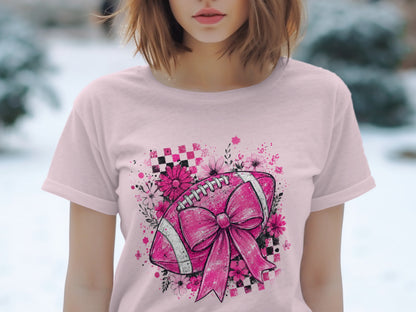 Pink t-shirt with a pink football graphic featuring a large bow and floral elements.