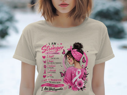 T-shirt with "I am Stronger than Yesterday" text and breast cancer ribbon design.