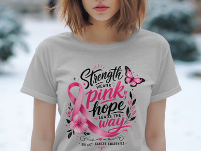 Gray t-shirt with pink ribbon, flowers, butterfly, and text "Strength Wears Pink, Hope Leads the Way"