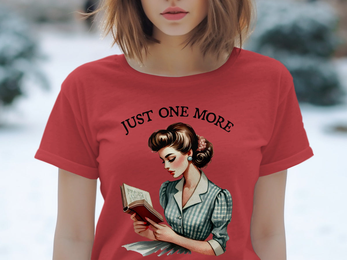 Red t-shirt with black text "JUST ONE MORE" and vintage illustration of a woman reading.