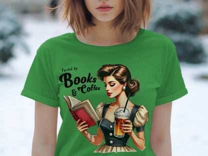 Green t-shirt with illustration of woman reading and drinking coffee, text "Fueled by Books & Coffee".