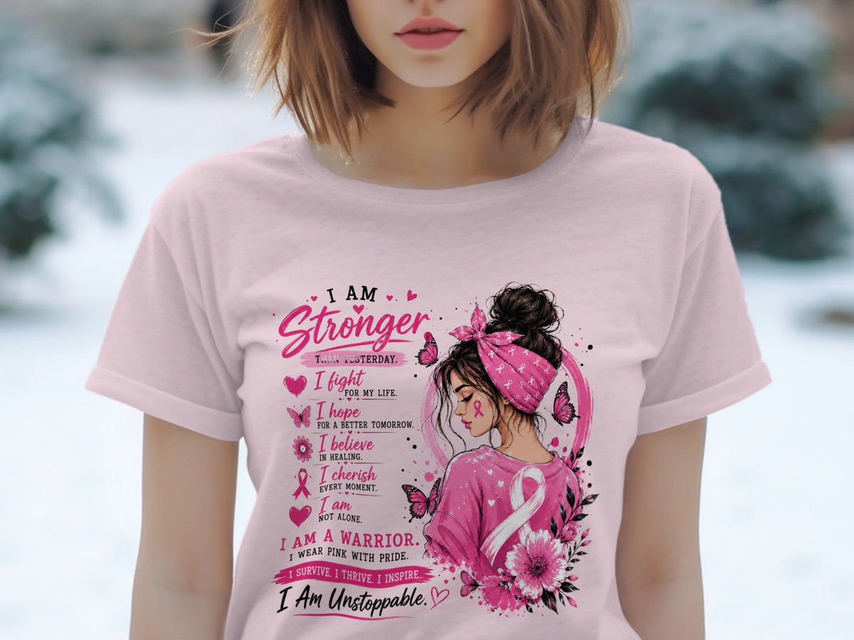 Pink shirt with "I Am Stronger Than Yesterday" and breast cancer awareness design.