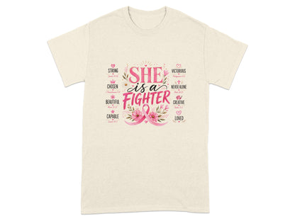 Cream t-shirt with "SHE is a FIGHTER" text and pink ribbon graphic.