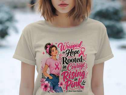 T-shirt with "Wrapped in Hope Rooted in Courage Rising in Pink" breast cancer awareness design.