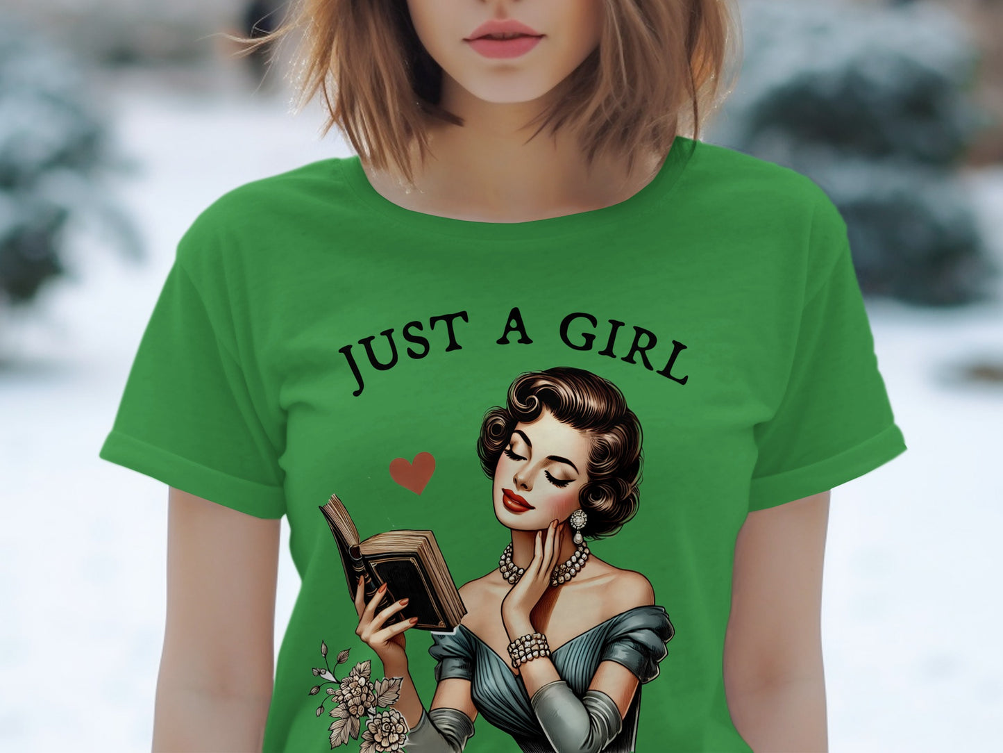 Green t-shirt with "JUST A GIRL" text and illustration of a woman reading a book.