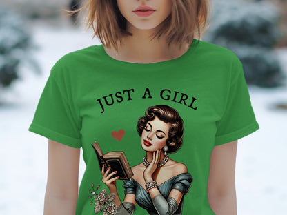 Green t-shirt with "JUST A GIRL" text and illustration of a woman reading a book.