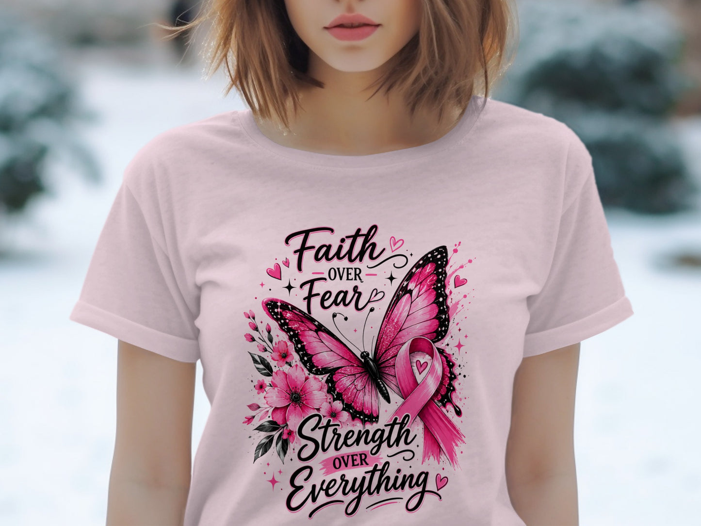 Pink t-shirt with butterfly, flowers, and text: "Faith OVER Fear", "Strength OVER Everything".