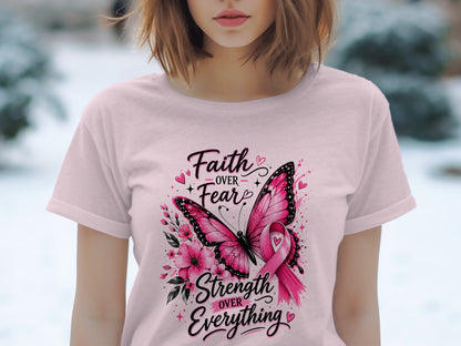 Pink t-shirt with butterfly, flowers, and text: "Faith OVER Fear", "Strength OVER Everything".