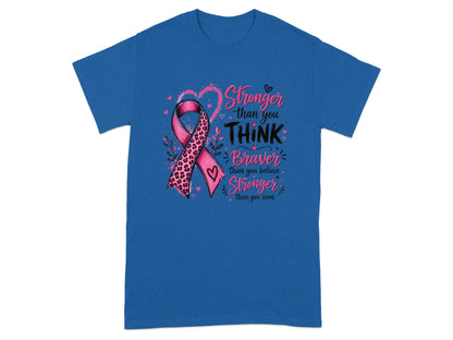 Blue t-shirt with pink ribbon design and text "Stronger than you THINK Braver than you believe Stronger than you seem".
