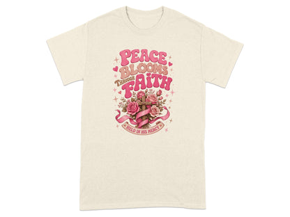 Cream t-shirt with "Peace Blooms Through Faith Held in His Mercy" text and floral cross.