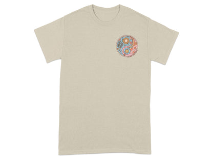 T-shirt with circular yin-yang design featuring flowers, suns, and text.