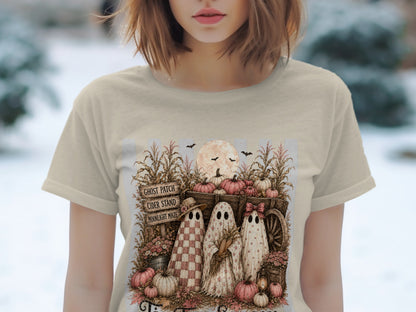 Three ghosts stand by a wagon filled with pumpkins, with signs for Ghost Patch and Cider Stand.