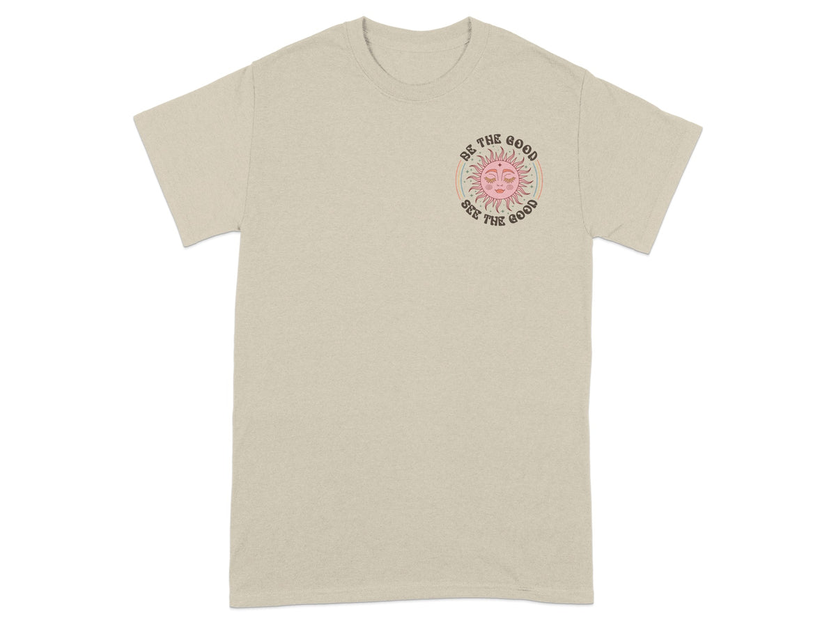 Beige t-shirt with a pink sun graphic and text "Be the good, See the good".