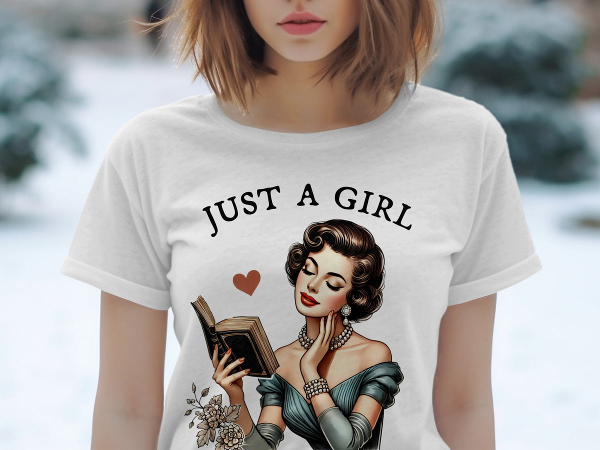 White t-shirt with "Just a Girl" text and vintage woman reading a book illustration.