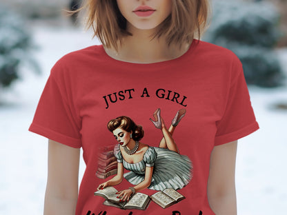 Red t-shirt with "JUST A GIRL" text and pin-up illustration of woman reading books.