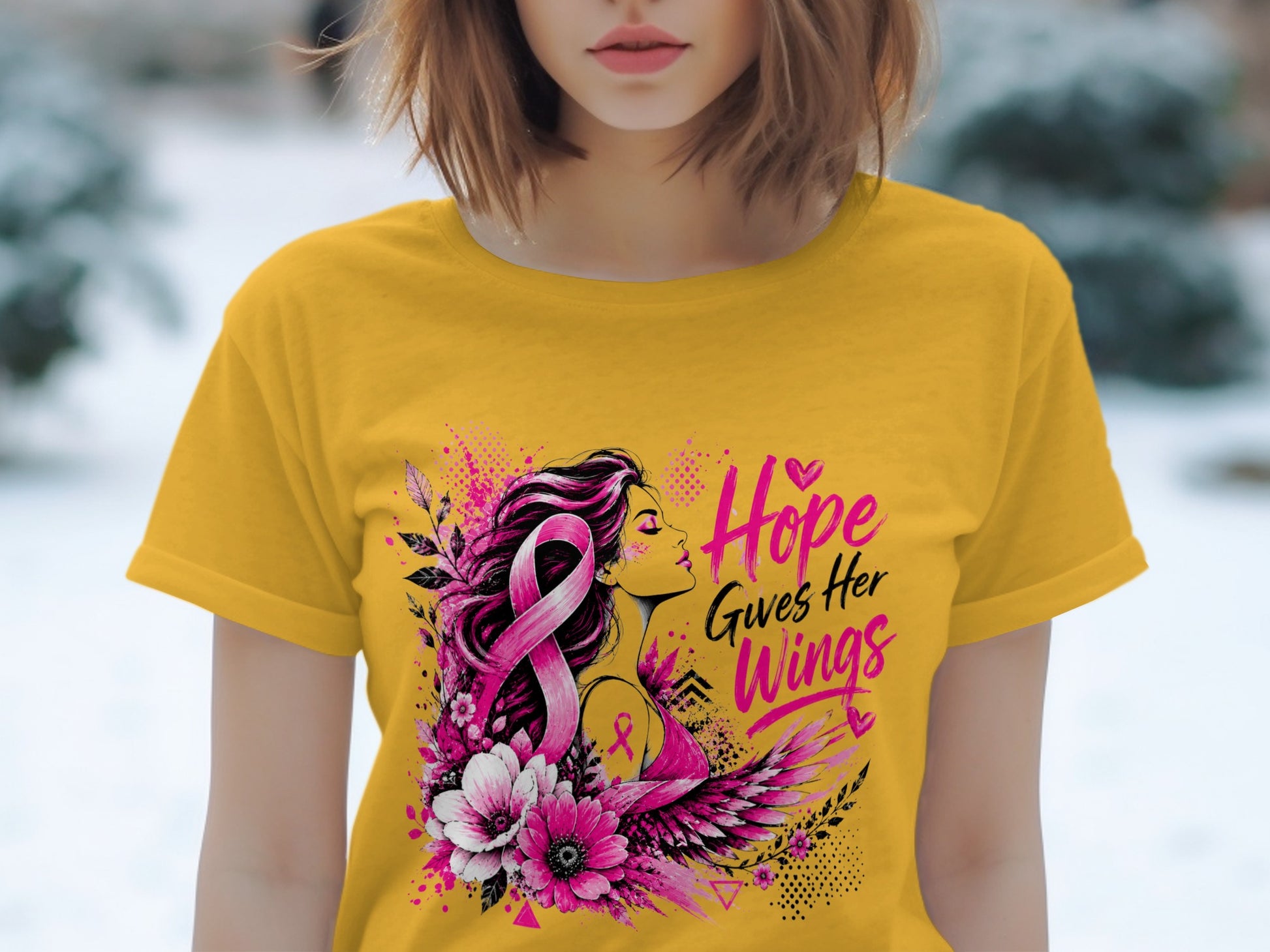 Yellow t-shirt with pink ribbon, woman, flowers, wings, and text "Hope Gives Her Wings."