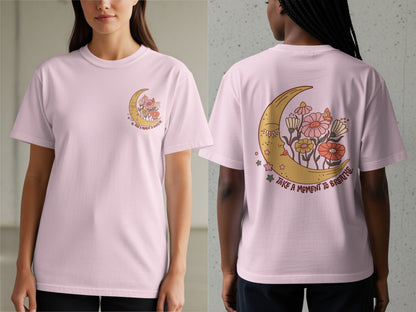 Pink t-shirt with a crescent moon, flowers, and the text "Take a moment to breathe".